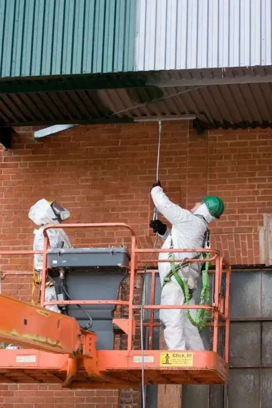 Power washing technicians beneath a deck | Gagnon Painting & Decorating, Southington